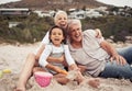 Family, time and beach with grandparents and grandchild laugh and play in sand, sitting and bonding in nature. Portrait Royalty Free Stock Photo