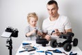 Family time: Dad and daughter repair the rc radio controlled buggy car model and lead a video blog.