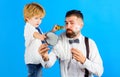 Family time. Fathers day. Son and Father shaving beard. Assistant for dad. Little barber. Barbershop. Royalty Free Stock Photo