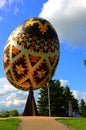 Family time in a park with a giant sculpture of a pysanka