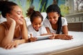 Family time-Smiling girl playing with mother and sister at home