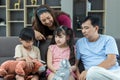 Family time together at home. Father and son and daughter sitting on sofa. Royalty Free Stock Photo