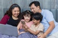 Family time together at home. Happy Family. Happy family and digital technology. family parents and son lying on the bed using sma Royalty Free Stock Photo