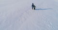 Family time walk and play together. Mother and son running hand in hand through the snow covered area in winter. back