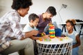 Family time. Young black parents with two kids playing together at home Royalty Free Stock Photo