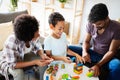 Family time. Young black parents with two kids playing together at home Royalty Free Stock Photo