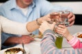 Family toasting water glasses in celebration