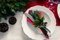 Family together Christmas celebration dinner table concept. Festive place setting for holiday dinner with natural decorations from Royalty Free Stock Photo