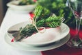 Family together Christmas celebration dinner table concept. Festive place setting for holiday dinner with natural decorations from Royalty Free Stock Photo