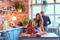 Family together cooking breakfast in loft style kitchen. Royalty Free Stock Photo