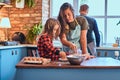 Family together cooking breakfast in loft style kitchen. Royalty Free Stock Photo