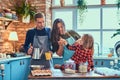 Family together cooking breakfast in loft style kitchen. Royalty Free Stock Photo