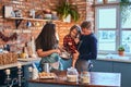 Family together cooking breakfast in loft style kitchen. Royalty Free Stock Photo