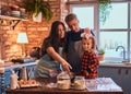 Family together cooking breakfast in loft style kitchen. Royalty Free Stock Photo