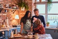 Family together cooking breakfast in loft style kitchen. Royalty Free Stock Photo