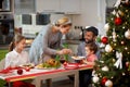 Family together at decorated table having festively dinner