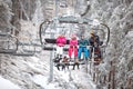 Family together in ski chair going to ski terrain Royalty Free Stock Photo