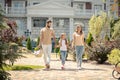 Young cute family walking vigorously and looking happy