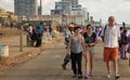 Family of tourist taking a walk among locals