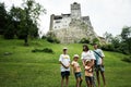 Family tourists against Bran Castle in Romania. Dracula medieval castle in Carpathians, Transylvania Royalty Free Stock Photo