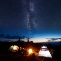 Family hikers having a rest at night camping in mountains Royalty Free Stock Photo