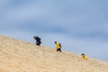 Family of tourists, parents with children, climbing the Pilat Dune Dune du Pyla.