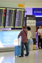 Family of tourists see the scoreboard in the interior of Bangkok airport