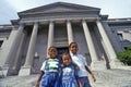 Family of tourists on the steps of the Benjamin Franklin Institute, Philadelphia, PA