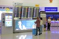 Family of tourists studying the scoreboard in the interior of Bangkok airport