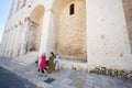 Family of tourists walking against Basilica of Saint Nicholas in Bari, Puglia, South Italy Royalty Free Stock Photo