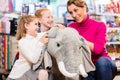 Family in toy store cuddling with stuffed animal