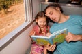 Family on the train reading a book