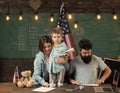 Family training. American family at desk with son making paper planes. Kid with parents in classroom with usa flag Royalty Free Stock Photo