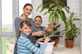 The family transplanted houseplants and joyfully looked into the frame