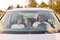 Family, transport, safety, road trip. Portrait of happy man and woman with little child in baby seat driving in car, expressing Royalty Free Stock Photo