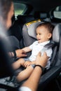 Family transportation, lifestyle concept - Safety first child seat, fastening seatbelt