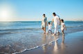 Family travel, beach walking and holding hands with mother, father and kids at ocean on holiday. Vacation and parent Royalty Free Stock Photo