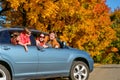 Family travel in car on autumn vacation, happy parents and kids have fun in trip Royalty Free Stock Photo