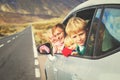 Family travel by car- happy father with kids on road in mountains Royalty Free Stock Photo