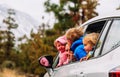 Family travel by car- happy mother with kids driving in mountains Royalty Free Stock Photo