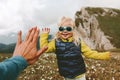 Family travel child high five hands with father hiking in mountains together Royalty Free Stock Photo