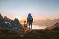 Family travel hiking adventures: father and child with backpacks in mountains of Senja island in Norway healthy lifestyle