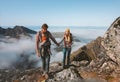 Family travel vacations man and woman hiking with baby carrier outdoor in mountains healthy lifestyle