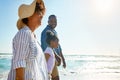 Family, travel and walking on a beach with a child or kid on vacation at the ocean or sea. Mock up, parents and happy Royalty Free Stock Photo