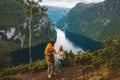 Family traveling in Norway together hiking above Geiranger fjord Father and mother with infant baby outdoor Royalty Free Stock Photo