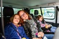 Family travelling in minivan to airport