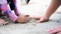 Family travels to the sea during summer holidays. Close Up father and daughter hands are building sand castle on beach. Royalty Free Stock Photo