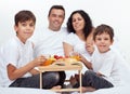 Family with two boys having breakfast in bed Royalty Free Stock Photo