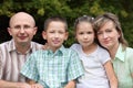 Family with two children in early fall park. Royalty Free Stock Photo