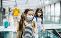 Family with two children going on holiday, wearing face masks at the airport. Royalty Free Stock Photo